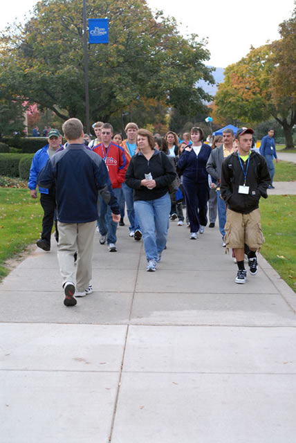Student Ambassador Brent K. Hey leads a tour group past the Hager Lifelong Education Center.