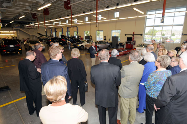 Colin W. Williamson, dean of transportation technology, center, shows off the new Honda laboratory, along with Steven H. Wallace, assistant dean (in tan jacket near right).