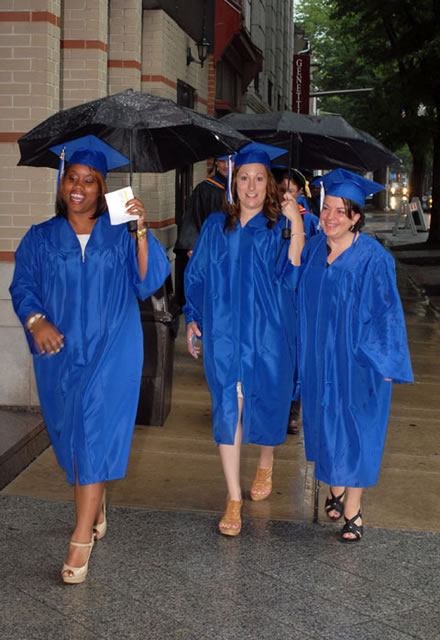 Soon-to-be-graduates, appropriately equipped for  but unfazed by  foul weather