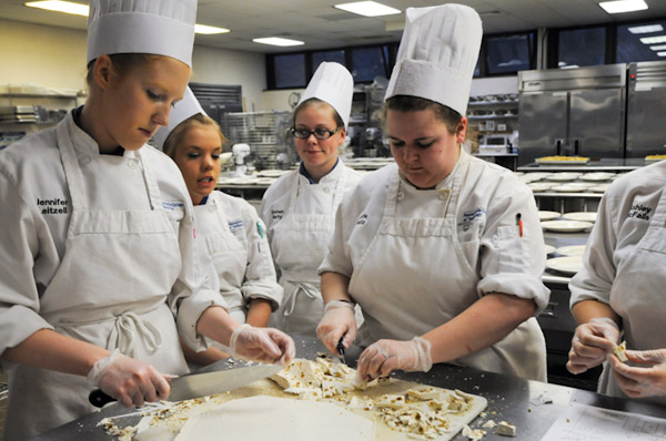 Baking and pastry arts students cut handmade nougat, an end-of-meal gift for the guests.