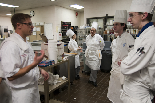 Chef Timothy Haire, banquet chef at 99 Cordova, talks with students in the Le Jeune Chef kitchens.
