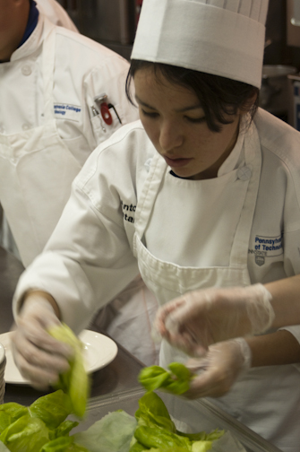 Culinary arts technology student Antonia Castaneda Bernal plates the salad course.