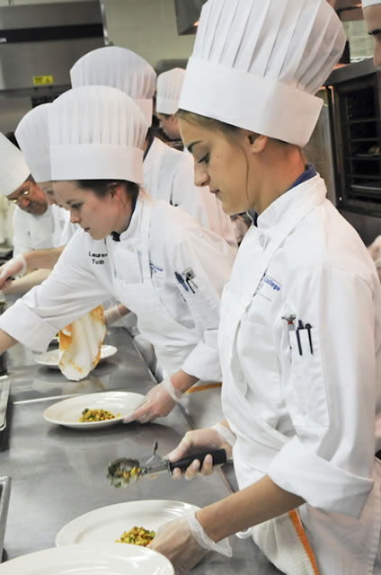 Student Amy E. Lynn adds roasted corn relish to the appetizer plate.