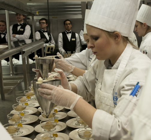 Baking and pastry arts student Denise Duitch pours ginger ale over ginger granite.