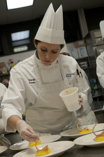Baking and pastry arts student Sarah Owen helps to prepare a dessert plate.