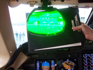 This photo of the plane's Head-Up Display shows that Lumley Aviation Center still is visible via synthetic vision, even when the pilot holds his notebook in front of the windscreen.