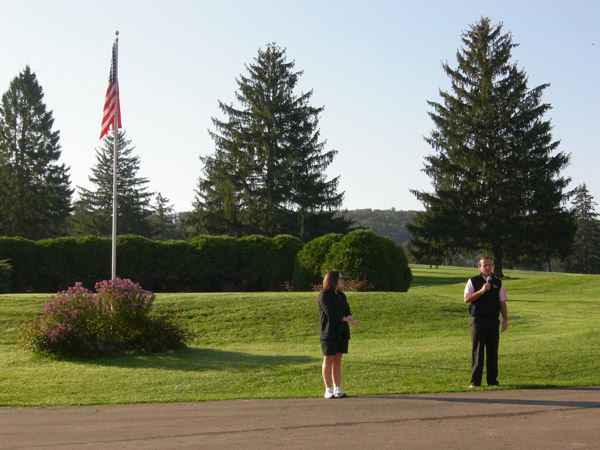 Valerie Fessler, alumni relations director, and Three Ponds pro Jonathan Hoffman welcome golfers.