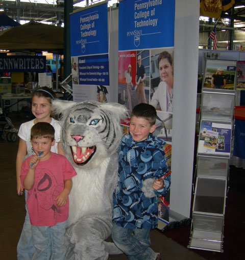 Another day, another fan club: The college's Wildcat mascot in a familiar environment, surrounded by smiling youngsters.