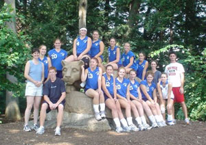 Members of the Wildcat women's volleyball team (with coach Bambi Hawkins at left) gather around Penn State's Nittany Lion statue during this past weekend's CCAC tournament at University Park. Accompanying the team were students Cody Umberger (Engineering) and Kyle Flook (Business Management), whose help included keeping statistics and working as line judges. The team went 8-0 in tournament play. 