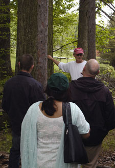 Dennis F. Ringling points out a 1910-vintage red oak along one of the nature trails at the Earth Science Center.