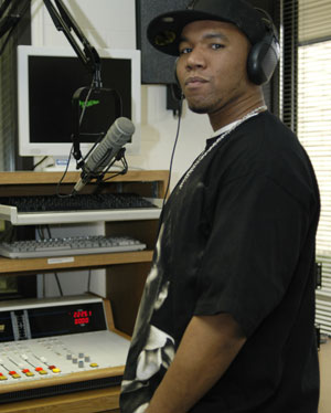 Terrance Cuff, known professionally as %22Miztasand,%22 works at the control board in the studio of WPTC-FM.