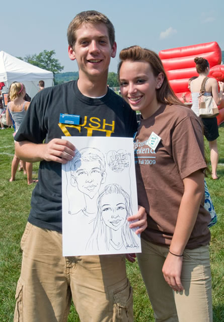 Justin A. Ball and Kattie I. Heisey show off their caricatured likenesses during Campus Fest.