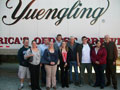 Accounting Society members gather outside the landmark Yuengling brewery with CEO Dick Yuengling (center) and adviser Phillip D. Landers (right).