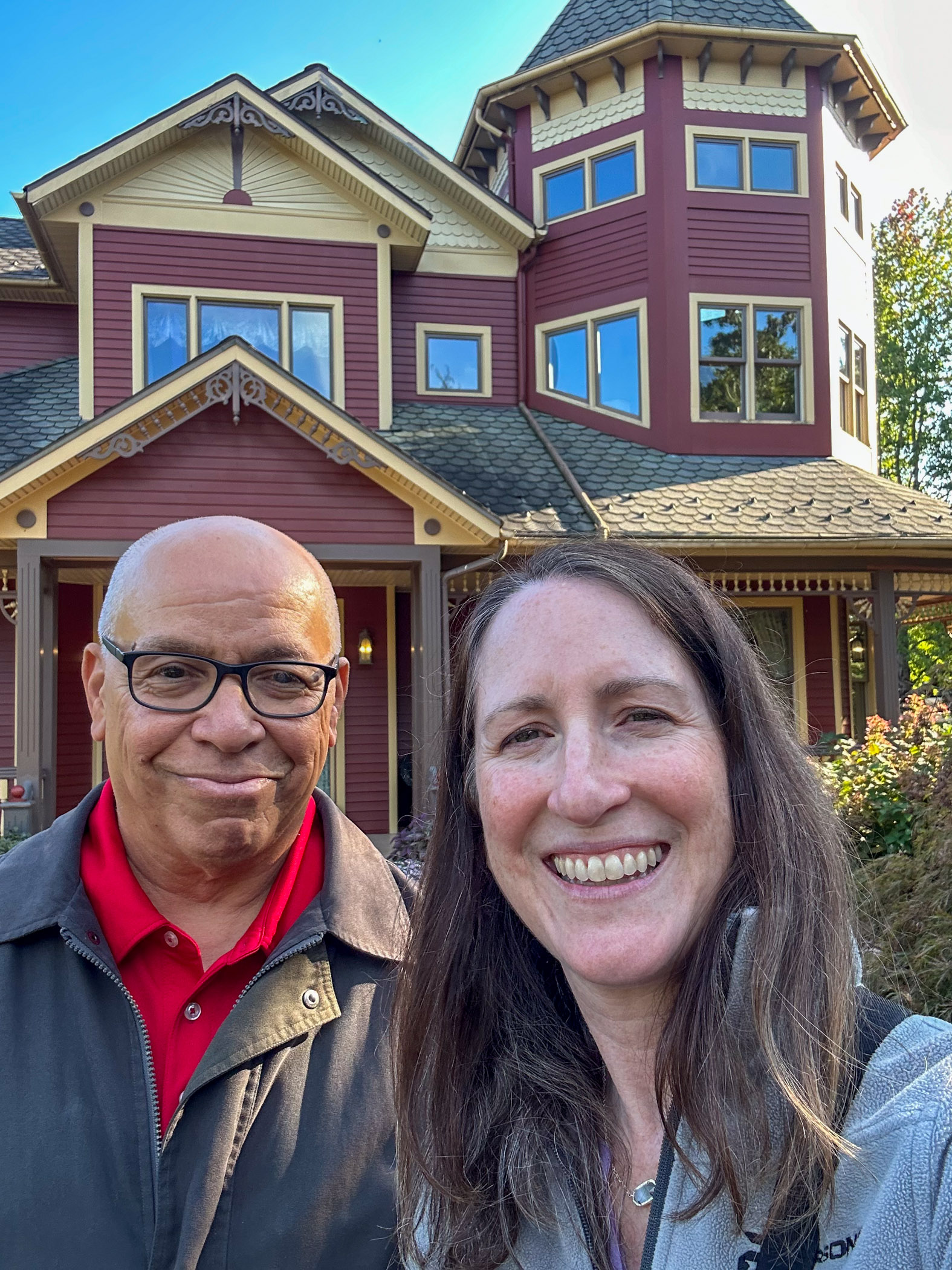 Raoul Ilaw and Heather Shinn pose in front of Penn College's Victorian House.