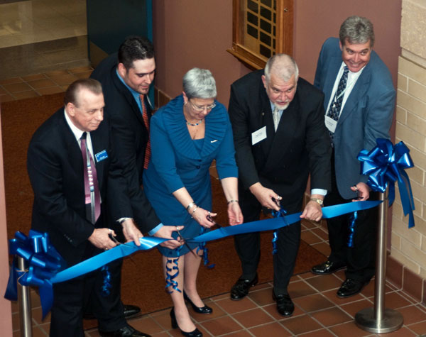 Dignitaries (from left) Hank White, director of the Plastics Manufacturing Center at Penn College; Todd Kennedy Jr., ’05, plant manager for McClarin plastics; Davie Jane Gilmour, Penn College president; Roger Kipp, of McClarin Plastics; and Tim Weston, associate professor and department head of plastics technology, cut the ribbon to celebrate advancements in education and research opportunities in the renovated plastics facilities.