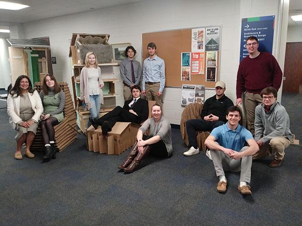 Putting the "fun" in "function," cardboard chair-designing BSD352 students display their obvious creativity in Penn College's architectural wing. Standing (from left) are Evynn Johnston, Draves, Burrows and Heigley. Seated (from left) are Gallick, Niedermyer, Cramer, Lawson, Weimert, Weissenberger and Zac Johnston.