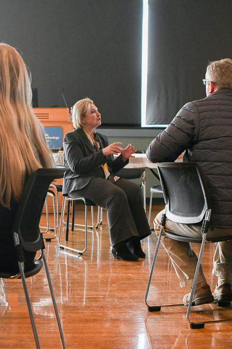 Alp builds bridges with co-workers, encouraging an exchange of ideas and taking notes for follow-up.