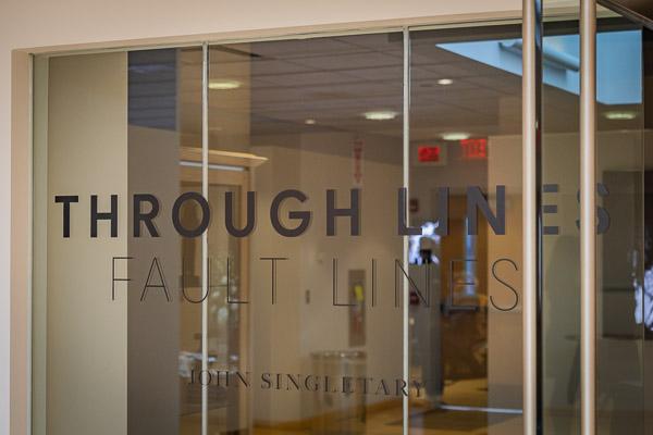 Titled glass beckons gallery-goers to the wonders within.