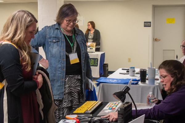  Meagan Murray (right) of the Roads to Freedom Center for Independent Living, talks with visitors about various assistive technology available on the market and through a lending library at Temple University. Murray holds a Penn College degree in human services (2009).