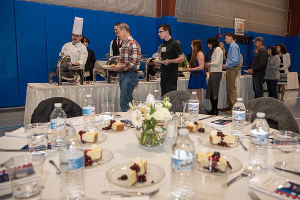 Guests line up for a delicious lunch catered by the college’s culinary experts.