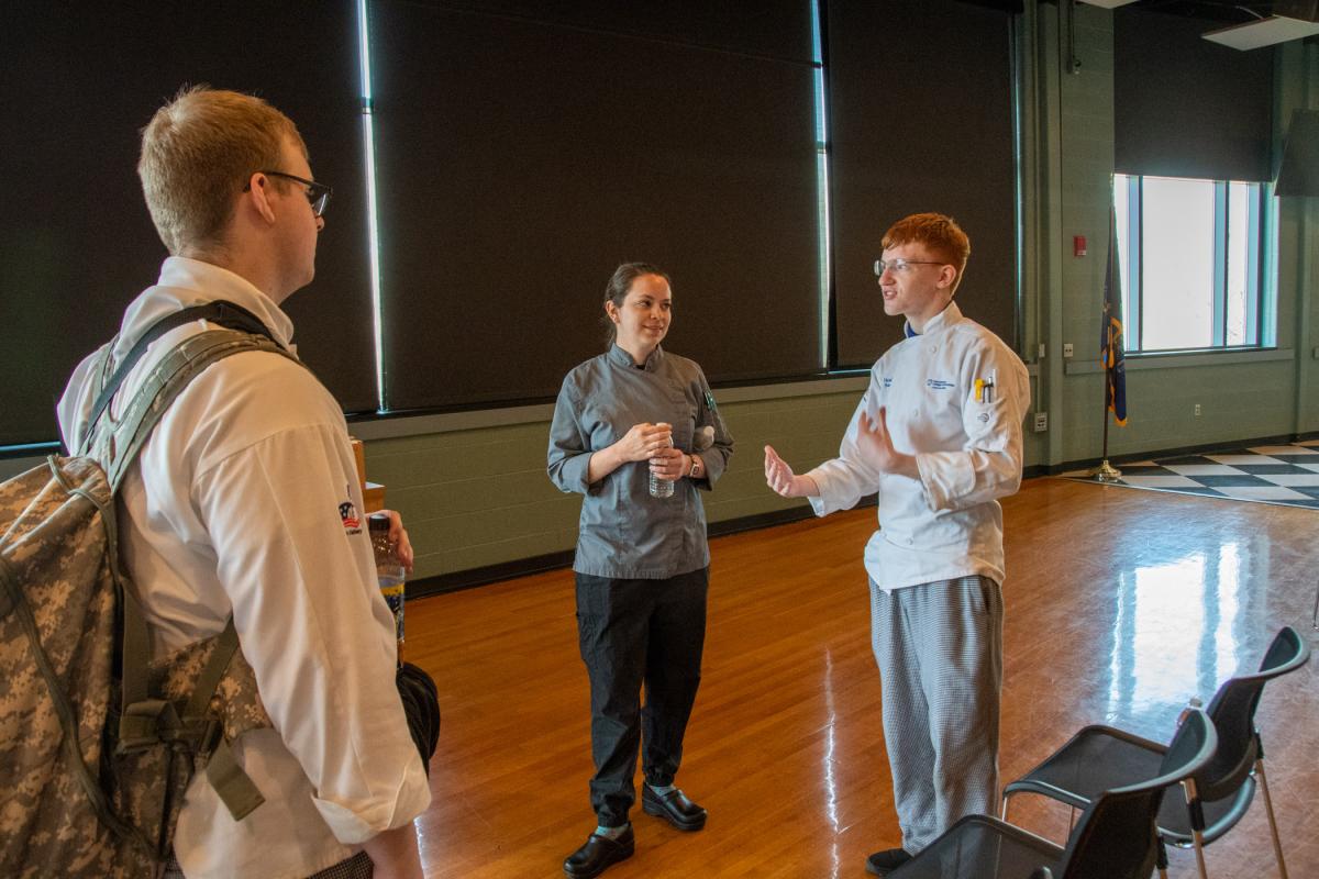 After a talk in Penn’s Inn, Wisneski answers follow-up questions with culinary arts technology students Gunner T. Vuocolo (left) of Lock Haven, and Noah W. Beck, of Port Matilda. 