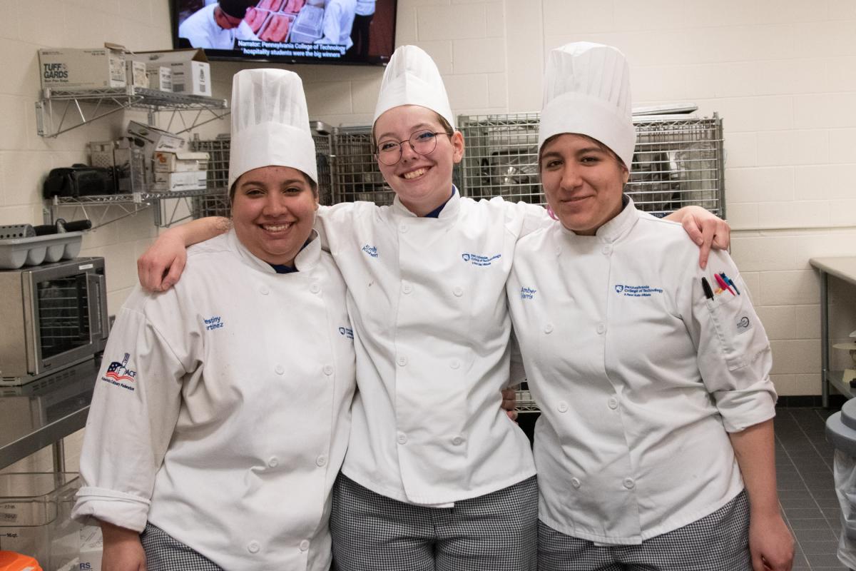 Baking & pastry arts students Destiny Y. Martinez, of Lancaster; Emily E.R. Kohen, of Mill Hall; and Amber R. Harris, of Sciota, provide a welcoming presence in a culinary lab as guests tour the facilities.