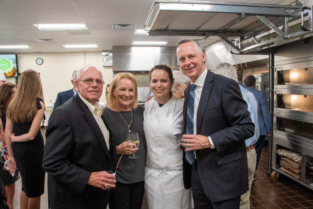 In the baking lab, Wisneski joins President Michael J. Reed (right) in welcoming John and Karen Blaschak, steadfast Penn College supporters. Karen is an honorary director of the Penn College Foundation Board.