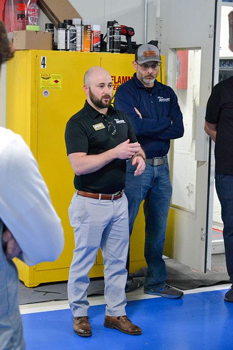 Caleb Pearson, collision center director, answers students' questions.