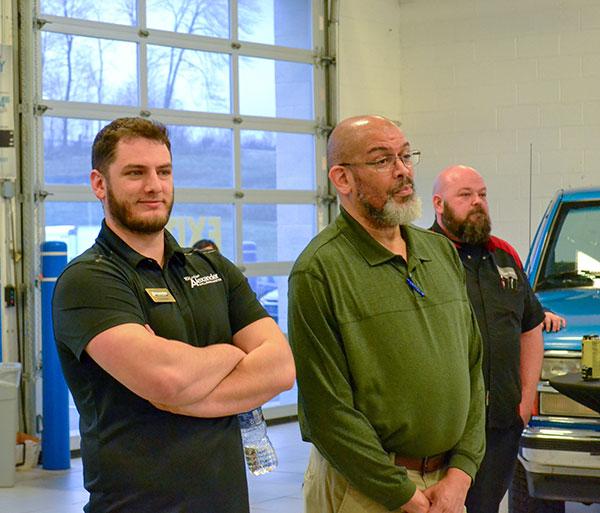 Automotive instructor Eric D. Pruden stands between Helm (left) and Master Toyota Technician Jack Kepley during closing remarks by Adam Alexander.