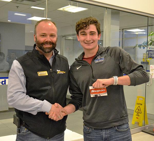 Aubrey Alexander congratulates William H. Roever II, of Moosic, majoring in automotive technology management: collision repair concentration, who won one of the night's two grand prizes: a $500 gift card from Snap-On Tools.