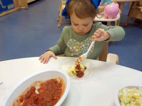 With I-can-do-it-myself determination, a child constructs lunch ...