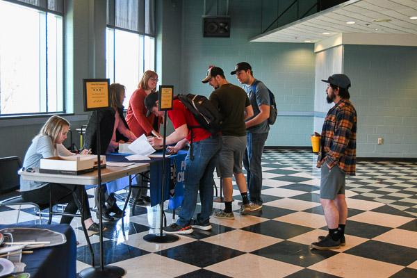 Students line up to receive their seven-ticket graduation allotment.