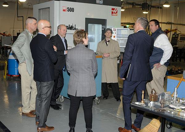 The group gathers around a Haas 5-axis Universal Machining Center in College Avenue Labs, just one example of the corporate philanthropy that helps Penn College create career-ready graduates.