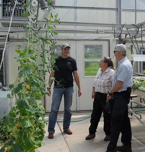 After Foreman expressed her interest in hydroponics, Easton (left) begins the tour inside an ESC greenhouse.
