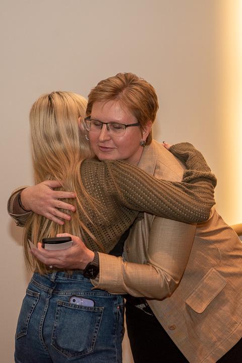 A warm embrace between Shannon M. Munro, vice president for workforce development, and Emily McGuinness cements a blessed bond.