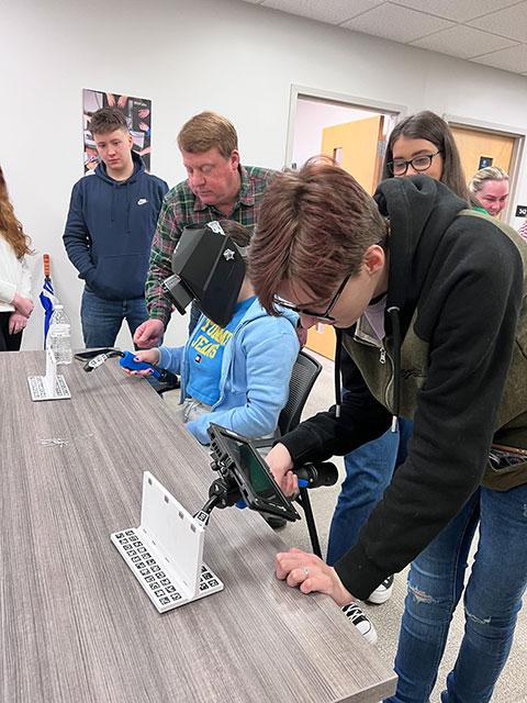 Mentored by Chris S. Macdonald (in plaid), corporate relations officer, the students experiment with welding simulators – just one of the hands-on revelations during their stay.
