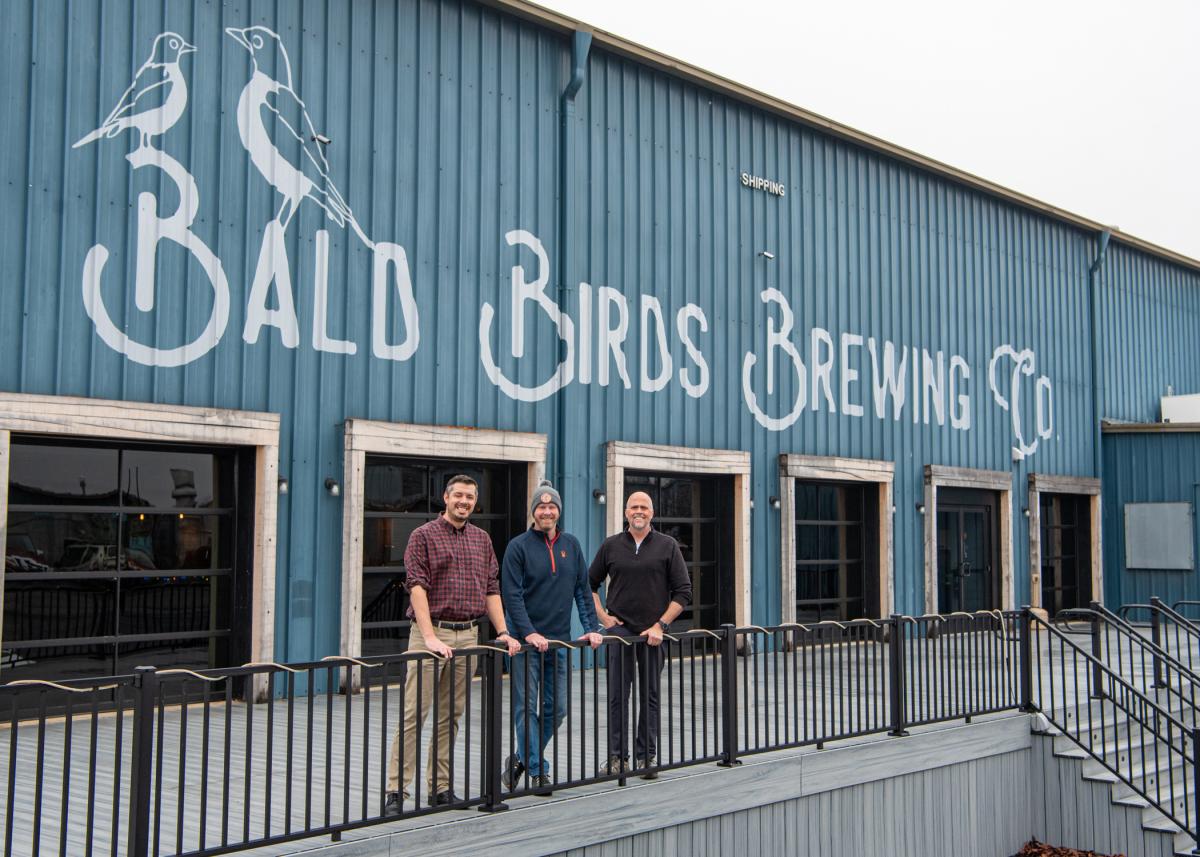 At Bald Birds Brewing Co. in Jersey Shore, owner Joey Feerrar (center) joins Pennsylvania College of Technology faculty Justin M. Ingram (left) and John F. Tamblin to celebrate the launch of the Penn College Brewing & Fermentation Research Lab.