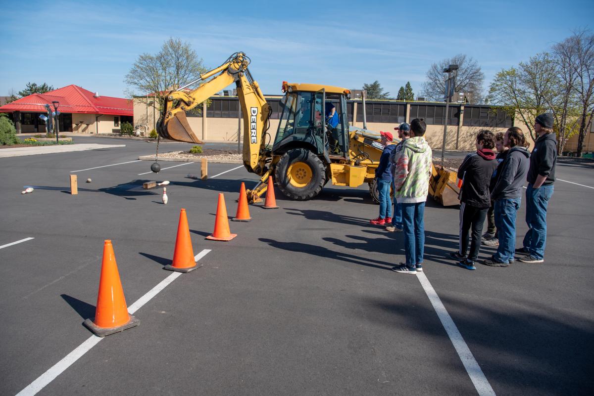 In one of eight lab experiences, offering visiting K-12 students a glimpse into majors aligning with emergency response careers, guests from Sullivan County High School engage in a heavy construction equipment demonstration in the Le Jeune Chef parking lot. 