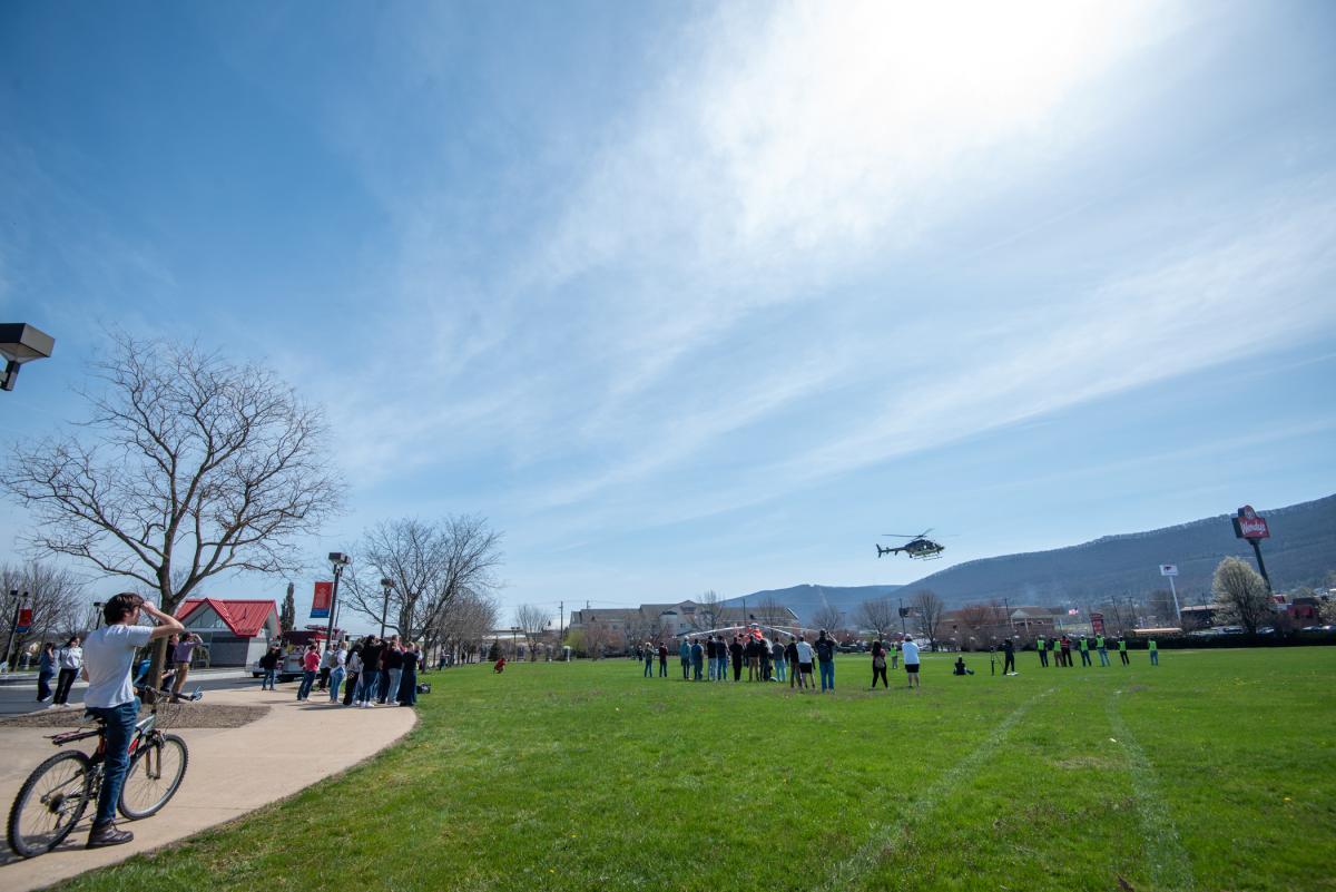 As the state police helicopter lifts off, throngs gather.