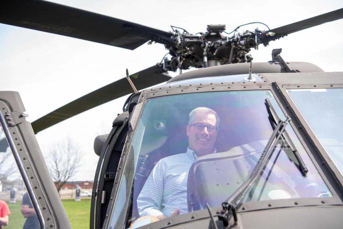 Ever the explorer, Rob Cooley, associate professor of anthropology/environmental science, checks out a Black Hawk’s interior and instrument panel. 