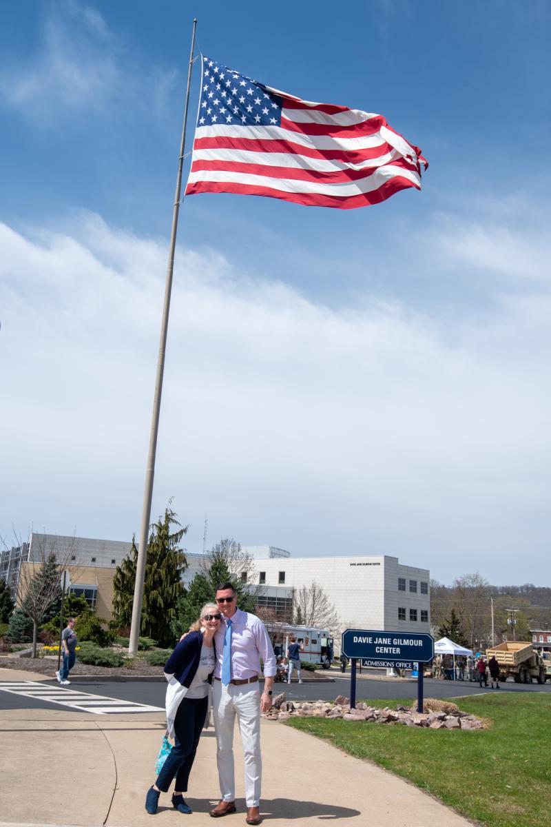 Per their usual level of campus participation, Erin S. and Walter J. Shultz step up to the plate (and flag) to enjoy the event. Erin is career and alumni engagement manager; Walter is a Navy veteran and director of educational and emerging technologies. 