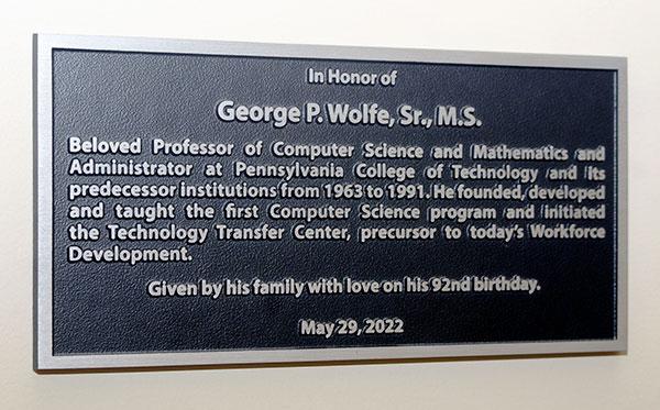 A family's love and respect is reflected on this memento, now hanging opposite Wolfe's former ATHS office.