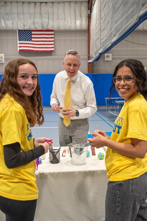"President Mike" sports a yellow tie in the company of dental hygiene students Erica N. Wenrich (left) and Ninoshka Rivera Matos. 