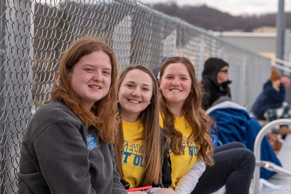  Fans in the stands! From left are Eryn L. Nichols, Jamie O. Krause and Morgan T. Bartholomew. Nichols and Bartholomew are Presidential Student Ambassadors.