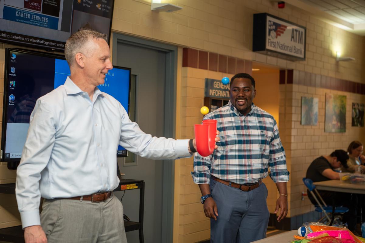 Reed and Woods delight in the juggling table’s array of props.