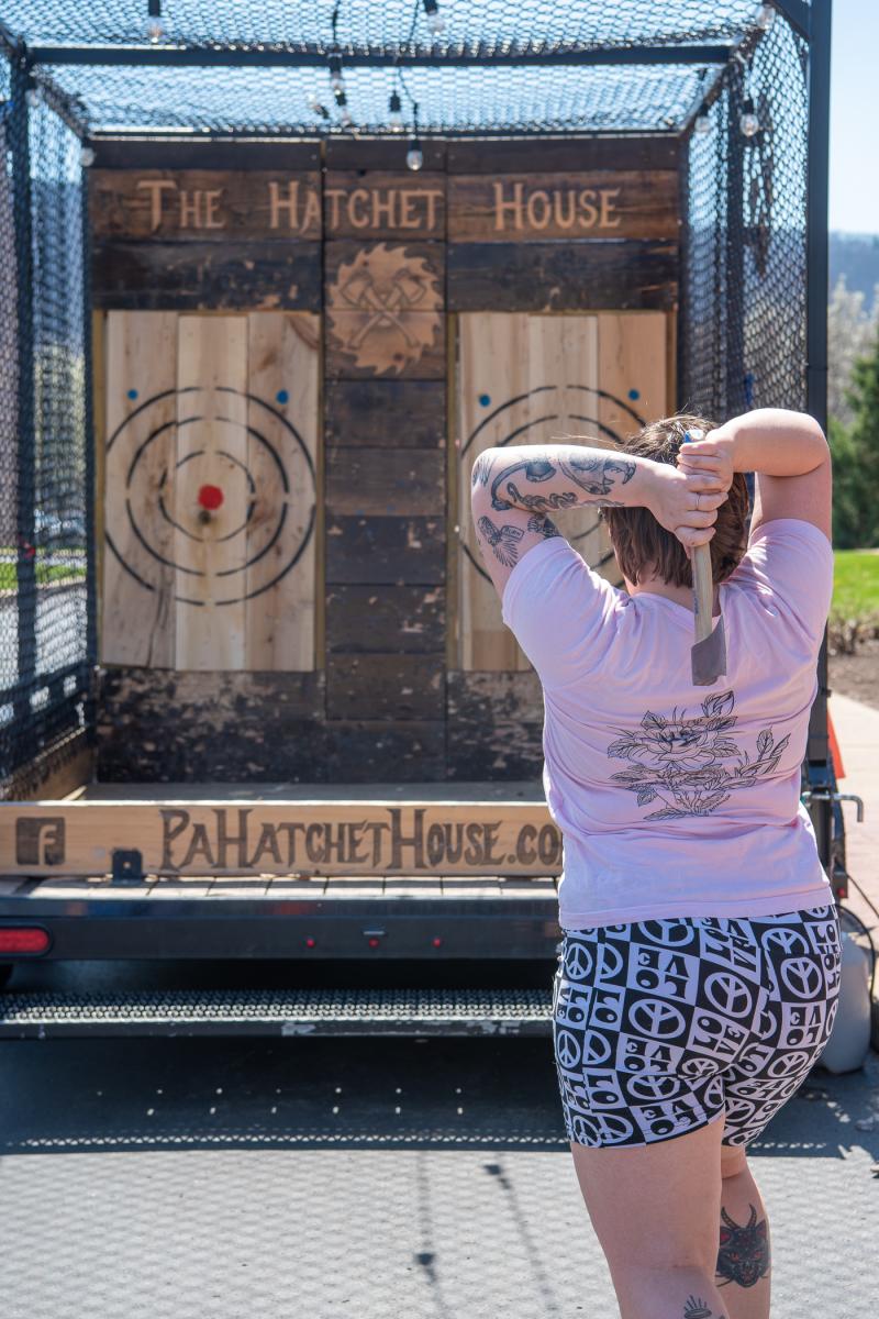 Peace and love shorts exuberantly blend with an ax from The Hatchet House as students relish various ways to release their stress. Other options outside the CC included unicycles, pogo sticks and yoga.