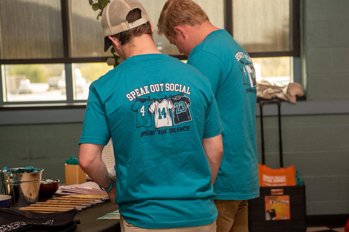 Event T-shirts declare the date and objective of the Speak Out Social.
