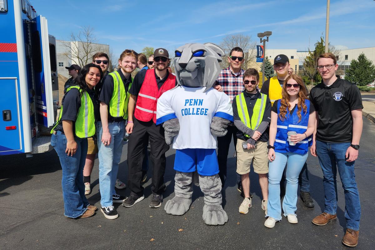 The Penn College Wildcat is bookended by the stars of the day: emergency management students and instructor David E. Bjorkman (in plaid shirt). 