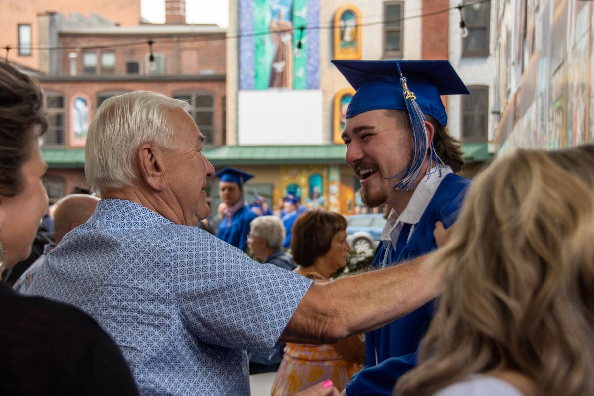 Ben Rich V, who earned dual associate degrees in diesel technology and electric power generation technology: diesel emphasis, connects with family following the morning ceremony.