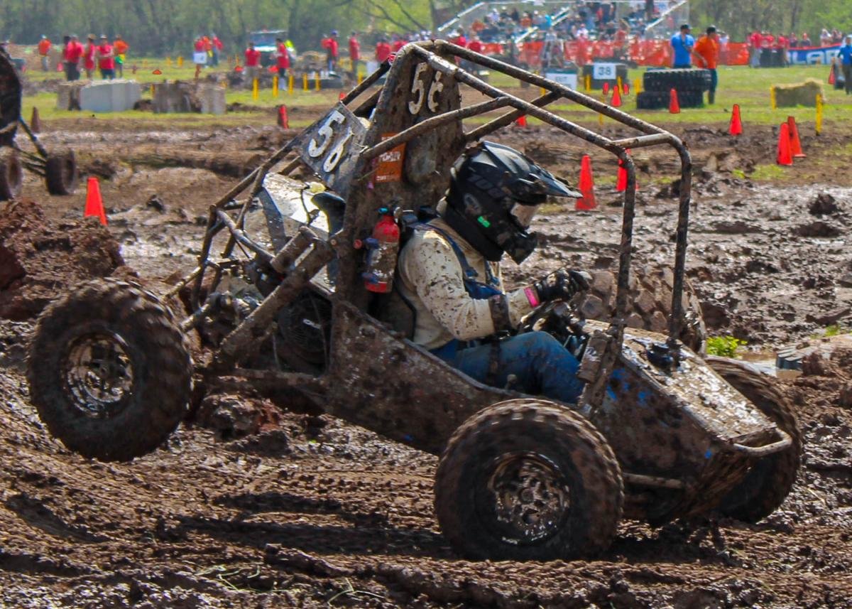 Pennsylvania College of Technology’s Isaac H. Thollot drives the school’s all-terrain vehicle through the mud at Baja SAE Oshkosh in Wisconsin. The Penn College entry finished 10th out of 57 cars in the four-hour endurance race. The Baja SAE club has existed at Penn College for 18 years, but this was the first time the team had to build a four-wheel-drive car for the competition. (Photo by Casey B. Campbell) 